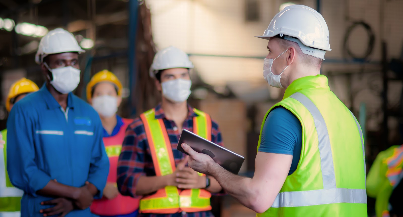 The manager or leader team is assignmenting a job for team of technicians, supervisor, foreman and engineers In the morning meeting before work In which everyone wear masks to prevent the coronavirus